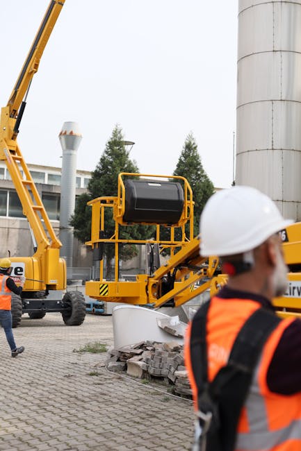 Construction workers and machinery at a site in İzmir, illustrating industrial teamwork outdoors.